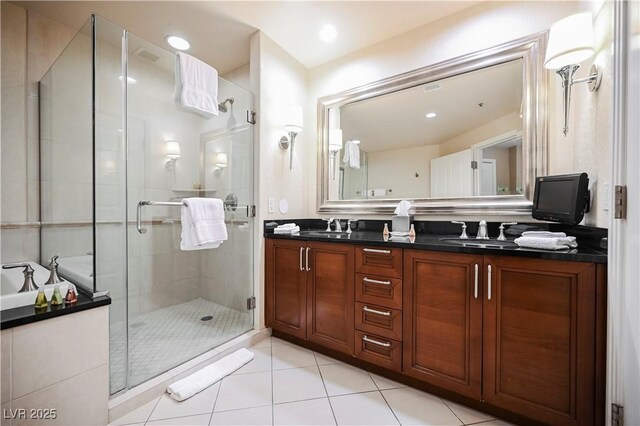 135 E Harmon Ave Unit 407, Las Vegas, NV 89109 - full bathroom with double vanity, a shower stall, tile patterned flooring, and a sink