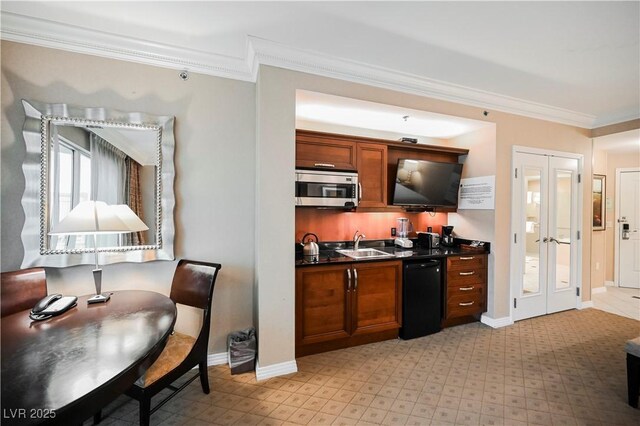 135 E Harmon Ave Unit 407, Las Vegas, NV 89109 - kitchen featuring a sink, stainless steel microwave, dark countertops, black dishwasher, and ornamental molding