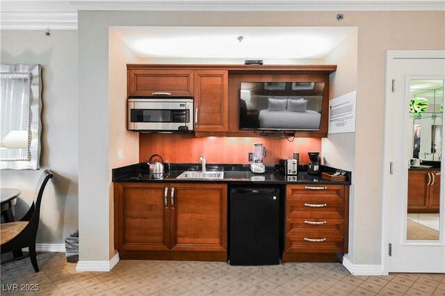 135 E Harmon Ave Unit 407, Las Vegas, NV 89109 - bar featuring baseboards, a sink, stainless steel microwave, and black dishwasher