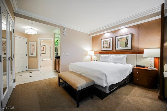 135 E Harmon Ave Unit 407, Las Vegas, NV 89109 - bedroom with ensuite bath, light tile patterned floors, and crown molding