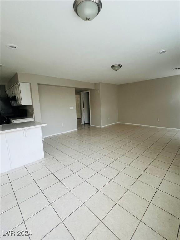 unfurnished living room with light tile patterned flooring