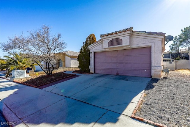 mediterranean / spanish-style home with a garage