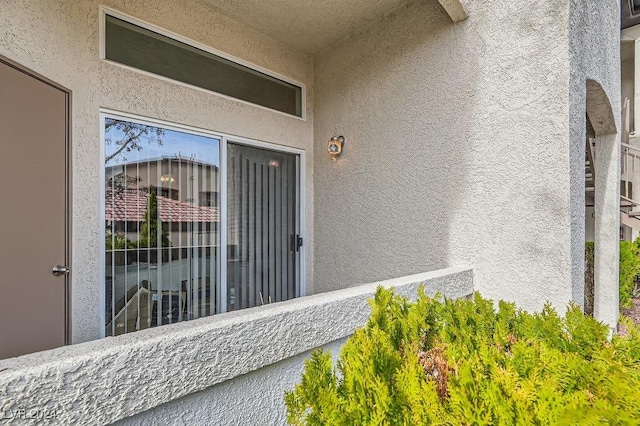 view of exterior entry featuring a balcony