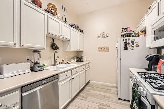 kitchen with white cabinetry, sink, and appliances with stainless steel finishes