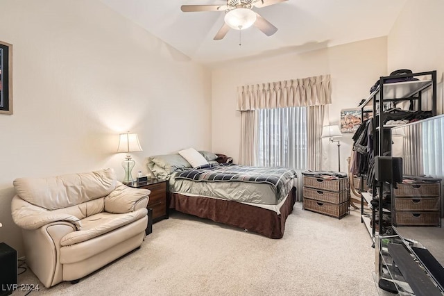 bedroom with ceiling fan, light carpet, and vaulted ceiling