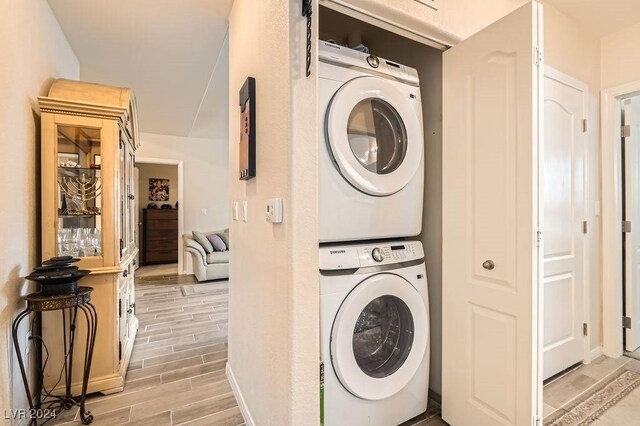 laundry room with stacked washer / dryer