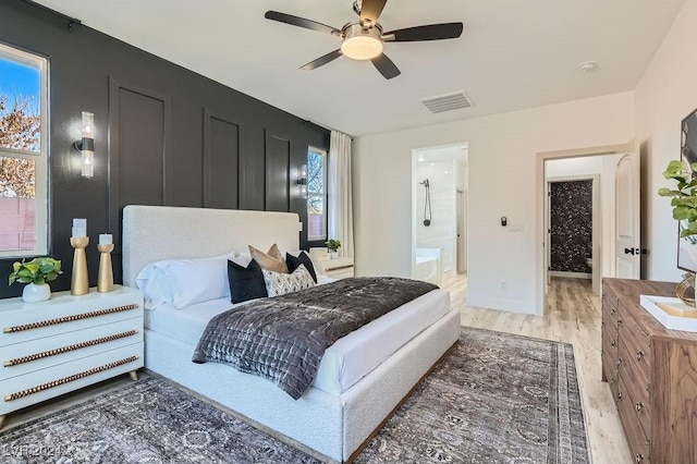 bedroom featuring ceiling fan, wood-type flooring, and ensuite bathroom