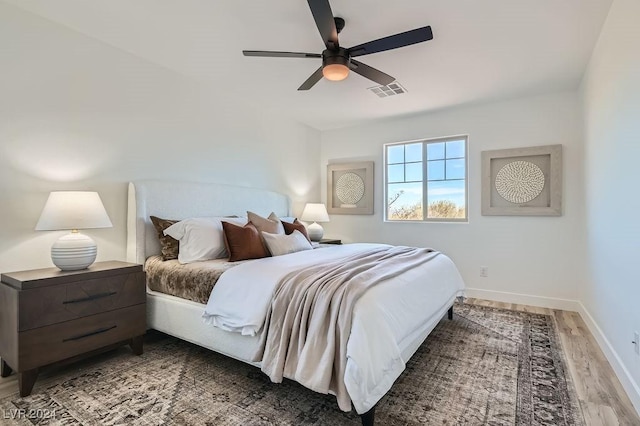 bedroom with hardwood / wood-style flooring and ceiling fan