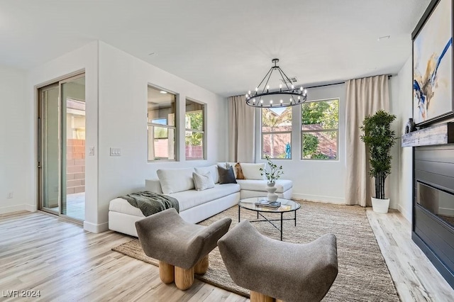 living room featuring an inviting chandelier and light hardwood / wood-style flooring