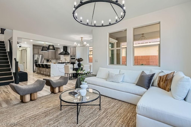 living room featuring light hardwood / wood-style floors and a chandelier