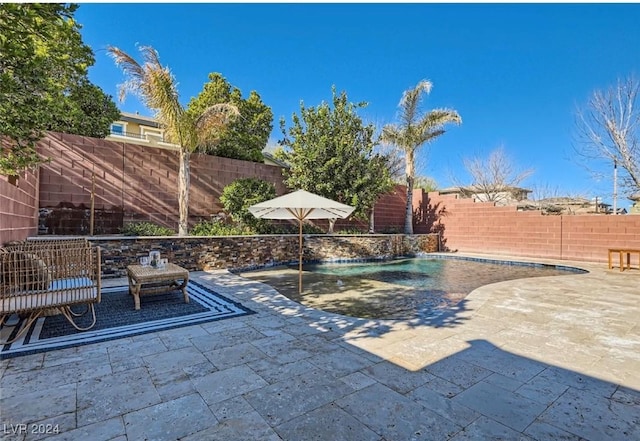 view of swimming pool with a patio and pool water feature