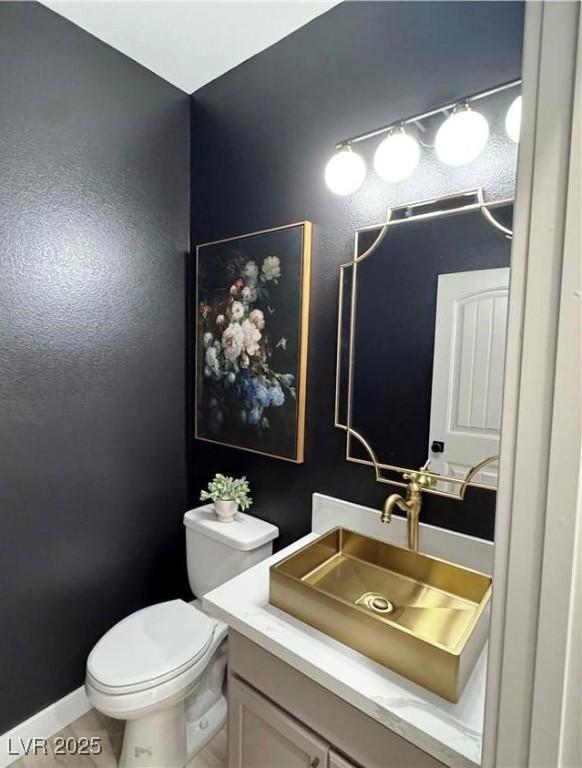 bathroom featuring vanity and toilet