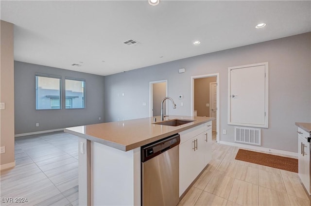 kitchen featuring sink, dishwasher, a kitchen island with sink, and white cabinets