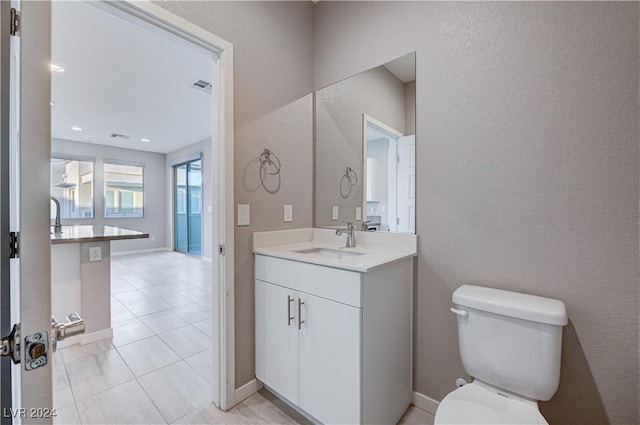 bathroom with toilet and vanity