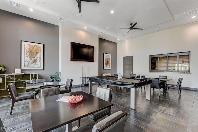 dining room featuring dark tile patterned flooring and ceiling fan