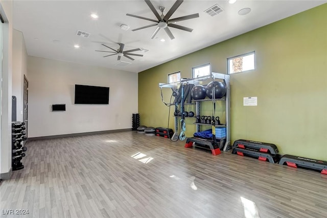 workout area with ceiling fan and light hardwood / wood-style flooring