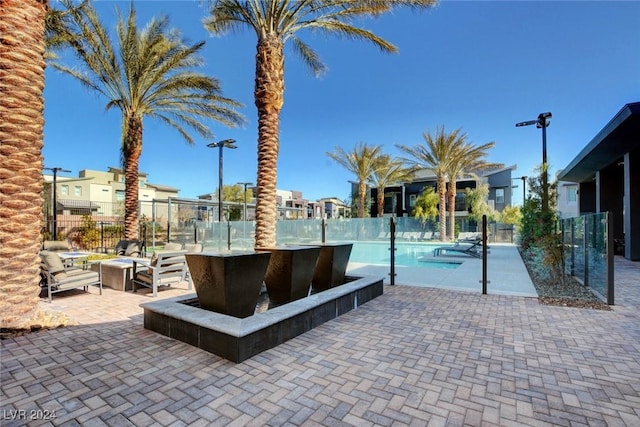 view of swimming pool with a patio and a bar