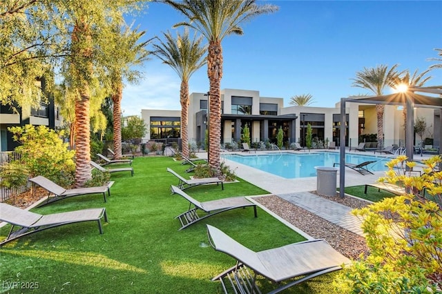 view of swimming pool with a yard and a patio area