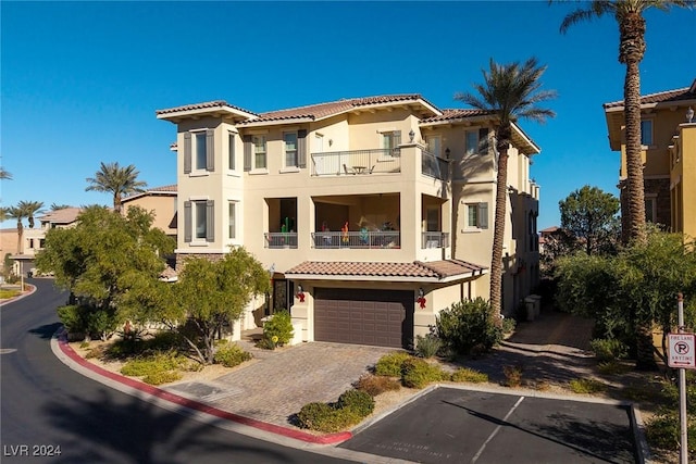 mediterranean / spanish home with a garage and a balcony