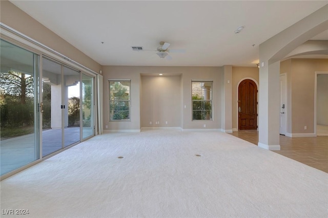 carpeted empty room featuring ceiling fan and french doors