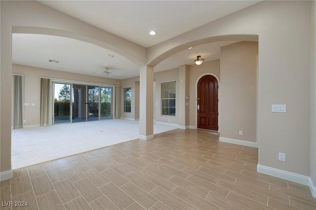 interior space with ceiling fan