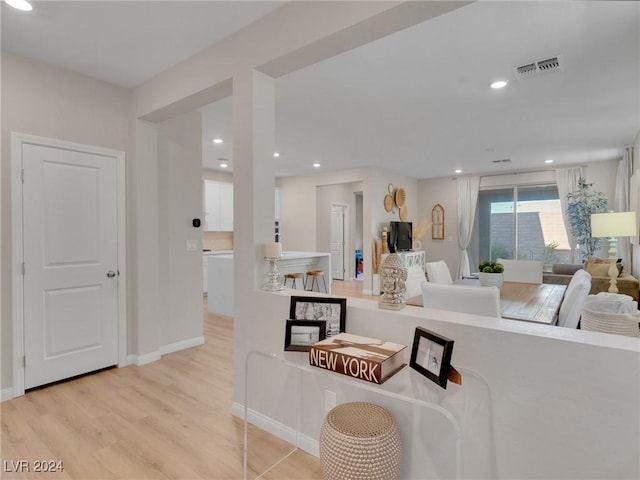 kitchen featuring light hardwood / wood-style floors and a fireplace