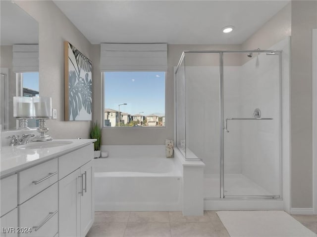 bathroom with plus walk in shower, vanity, and tile patterned floors