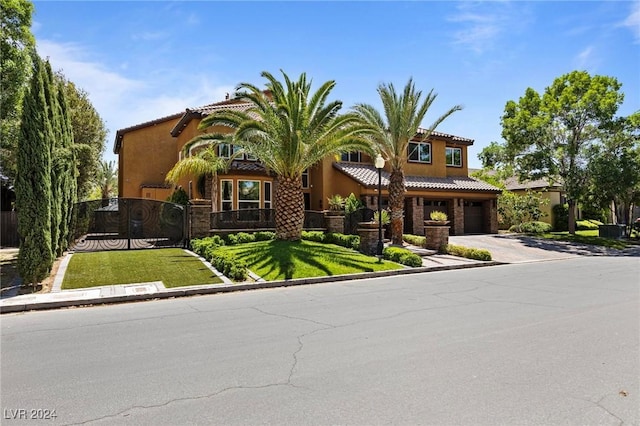 mediterranean / spanish home with a garage