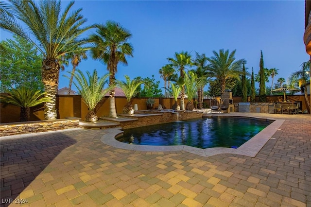 view of pool with a patio and an outdoor fireplace