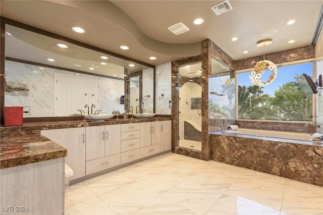 bathroom featuring vanity, tile walls, and tiled tub