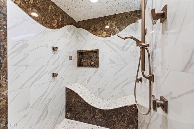 bathroom with a tile shower