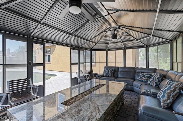 sunroom / solarium with ceiling fan and vaulted ceiling