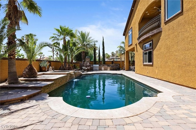 view of pool featuring pool water feature, a patio, and area for grilling