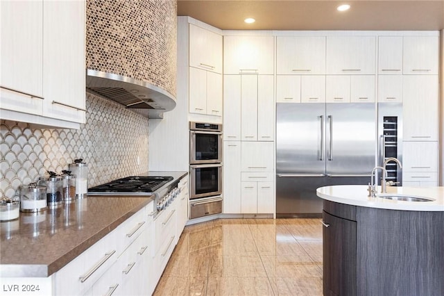 kitchen with sink, white cabinets, and stainless steel appliances