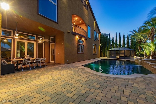 pool at dusk featuring a patio area