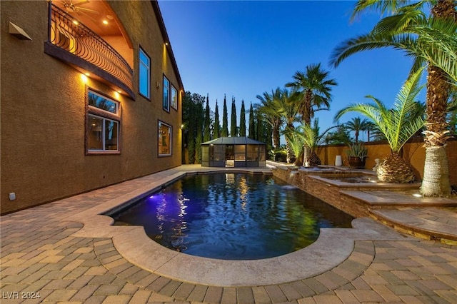 view of pool at dusk