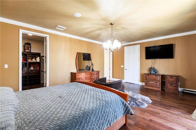 bedroom with hardwood / wood-style floors, a notable chandelier, and ornamental molding