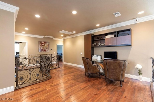 office area with wood-type flooring and ornamental molding