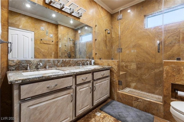 bathroom with vanity, a shower with door, crown molding, toilet, and tile walls