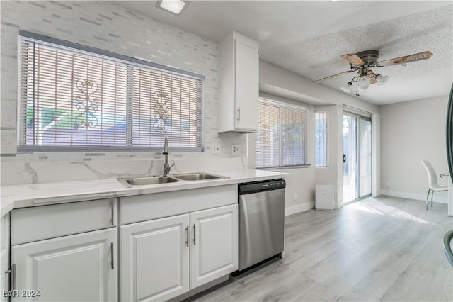 kitchen featuring a textured ceiling, dishwasher, white cabinetry, sink, and ceiling fan