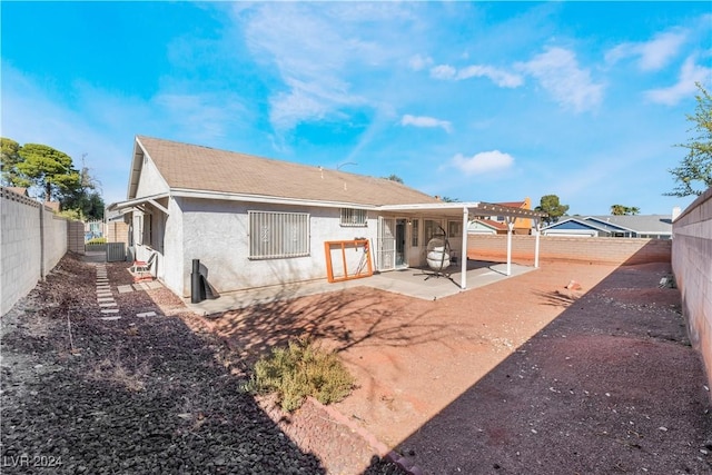 rear view of property featuring a patio area