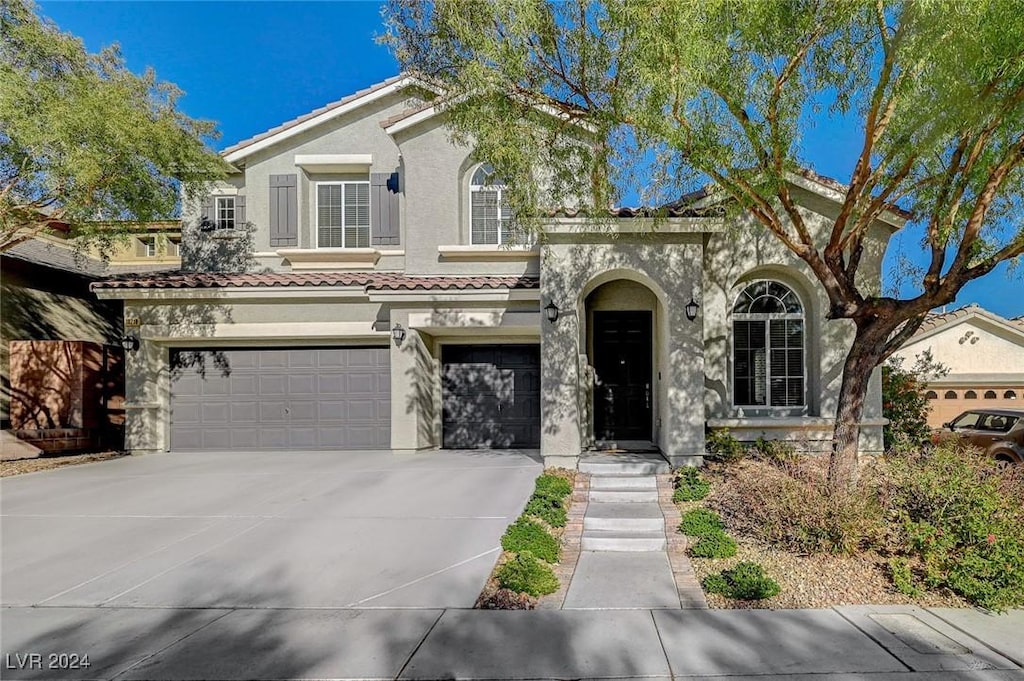 mediterranean / spanish-style house featuring a garage