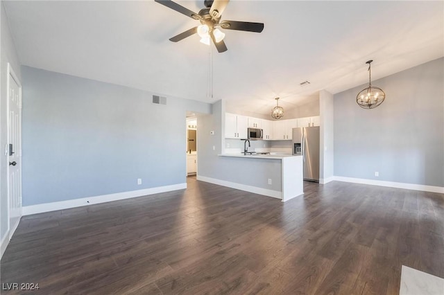 unfurnished living room featuring ceiling fan with notable chandelier, dark hardwood / wood-style flooring, lofted ceiling, and sink