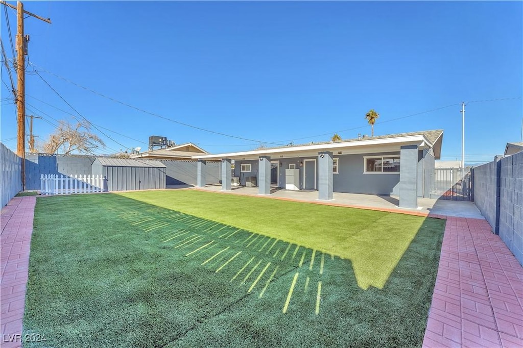 back of house featuring a yard and a patio