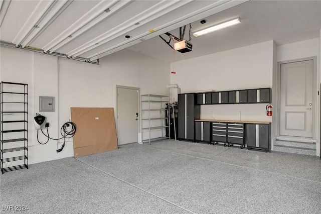 garage with electric panel and a garage door opener