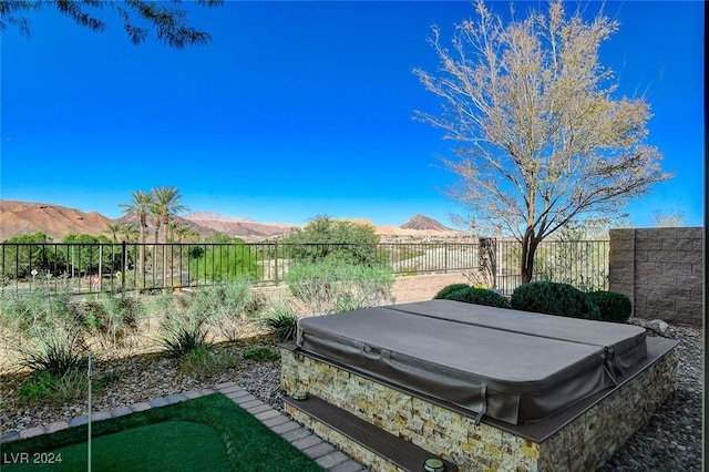 view of yard featuring a covered hot tub and a mountain view