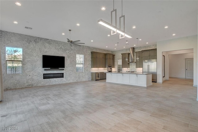 unfurnished living room with ceiling fan and sink