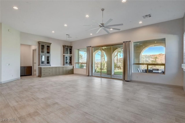 unfurnished living room featuring ceiling fan