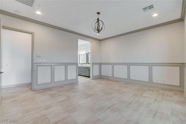 unfurnished room featuring crown molding and an inviting chandelier