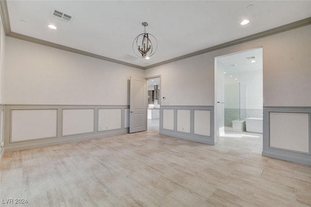 empty room with crown molding and a chandelier